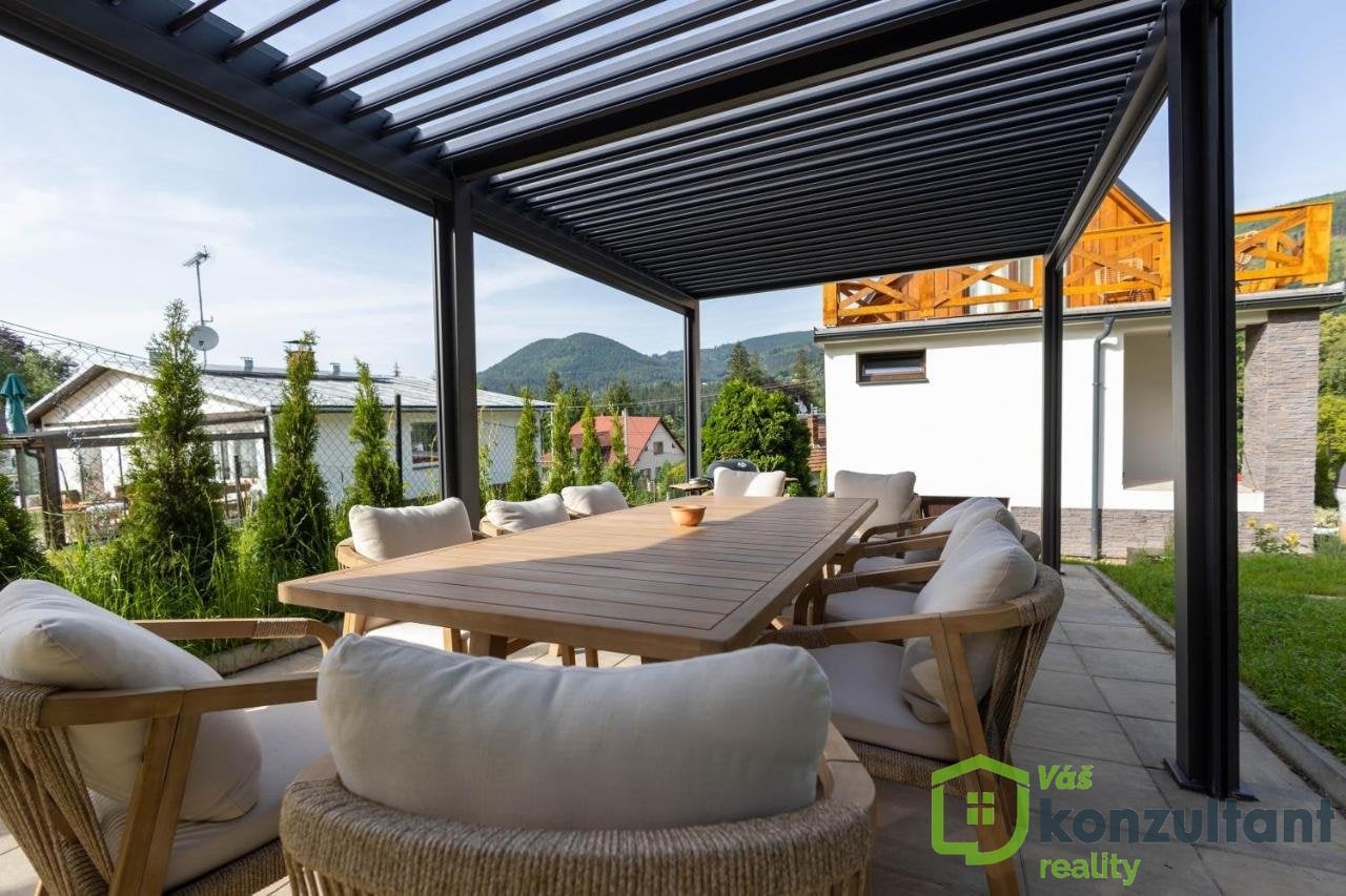 Krytá venkovní terasa s jídelním sezením a výhledem na Beskydy